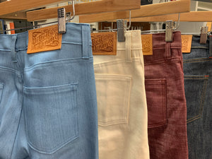 a variety of detroit denim sustainable custom jeans hanging